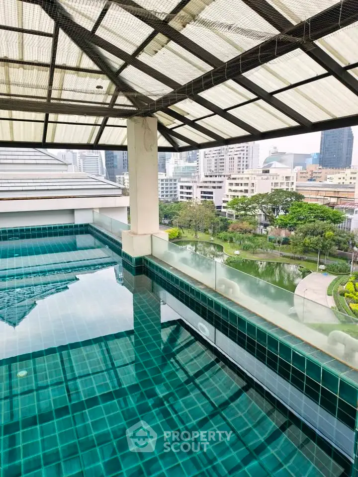 Stunning rooftop pool with panoramic city views and lush greenery, perfect for relaxation and leisure.