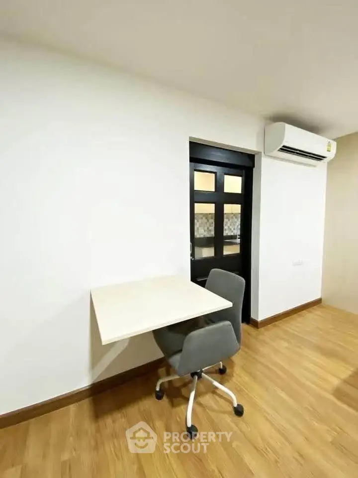 Modern study area with sleek design and air conditioning in a contemporary apartment.