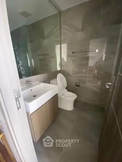 Modern bathroom with sleek fixtures and elegant tile design, perfect for a contemporary home.