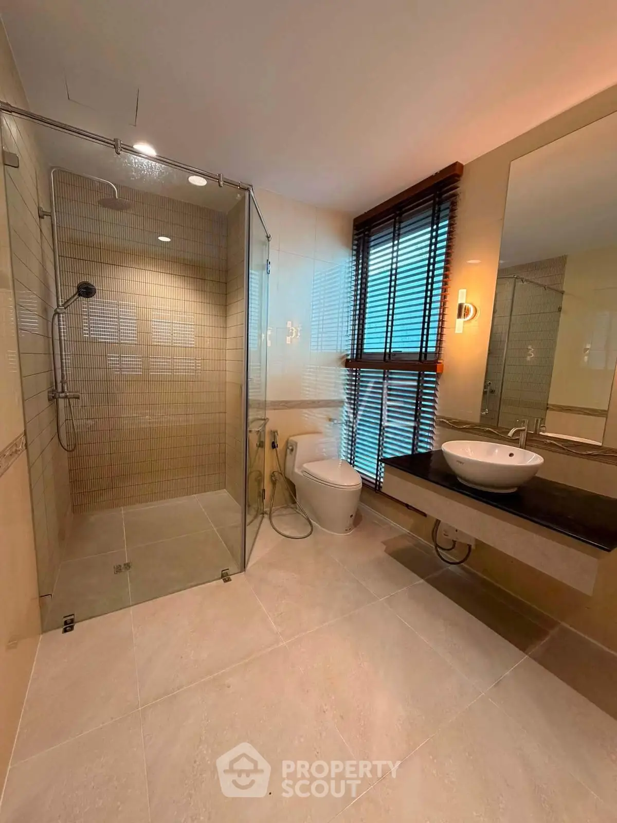 Luxurious modern bathroom with glass shower and elegant fixtures
