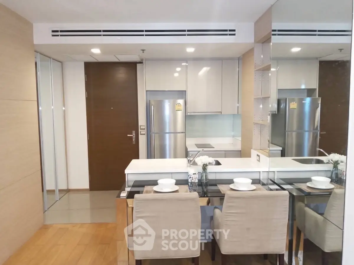Modern kitchen with dining area featuring sleek appliances and stylish decor
