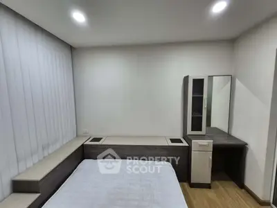 Minimalist bedroom with modern furniture and soft lighting