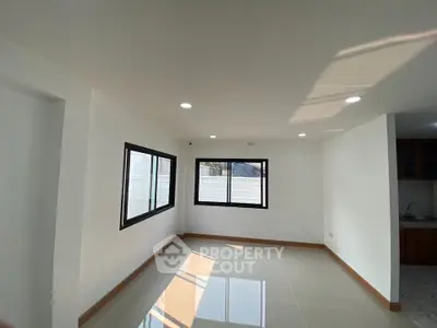 Bright and spacious room with large windows and glossy tiled floor