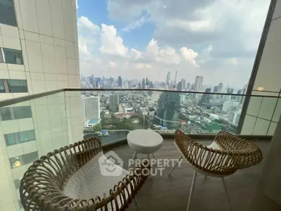 Stunning high-rise balcony with panoramic city views and stylish outdoor seating.