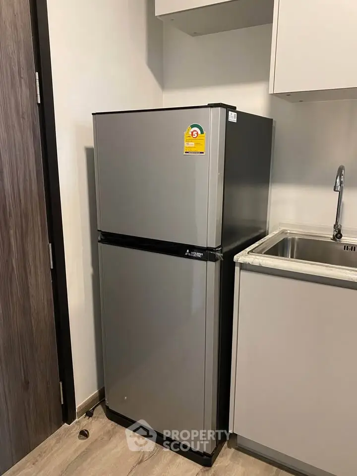 Modern kitchen with sleek refrigerator and stainless steel sink