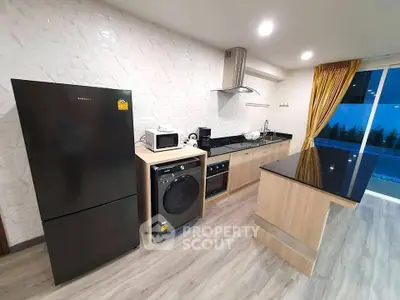 Modern kitchen with sleek appliances and stylish island in open layout