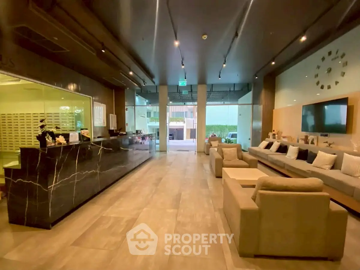 Luxurious building entrance with modern seating and elegant decor