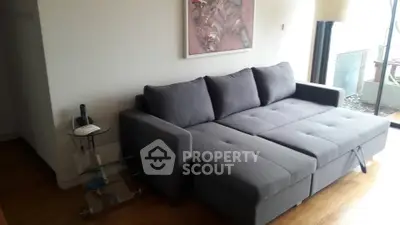 Modern living room with stylish gray sofa bed and elegant decor