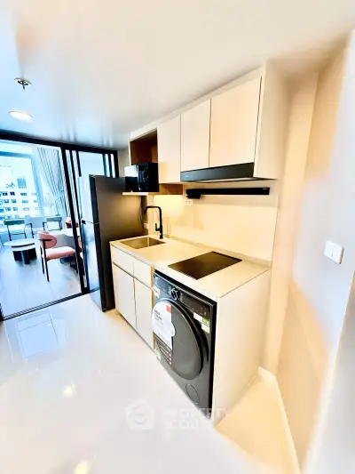 Modern kitchen with sleek appliances and open layout in a stylish apartment