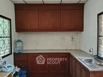 Charming kitchen with wooden cabinets and natural light, perfect for cozy cooking experiences.
