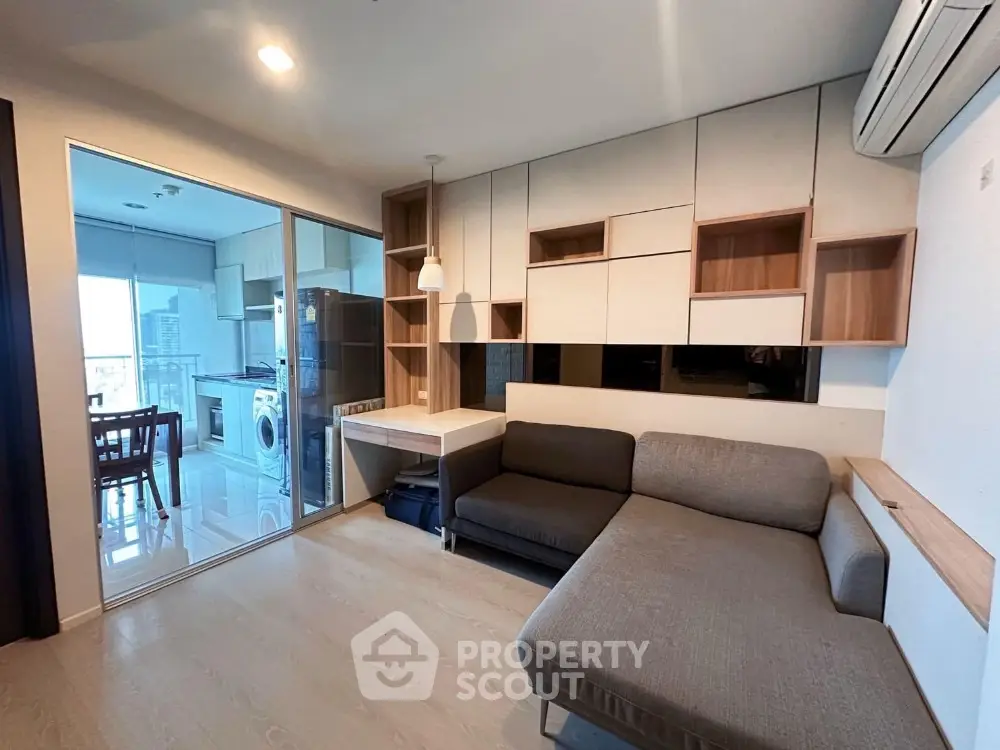 Modern living room with stylish furniture and open kitchen layout in a contemporary apartment.