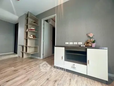 Modern living room with stylish wooden flooring and built-in shelving unit.