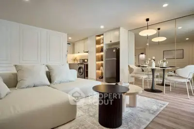 Modern open-plan living room with stylish furniture and kitchen appliances