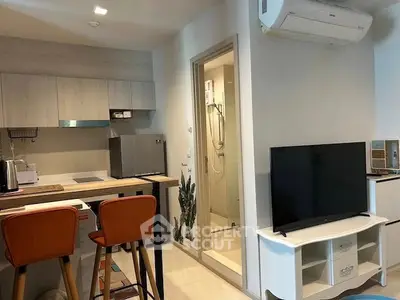 Modern apartment interior with kitchen and living area featuring stylish furniture and appliances.