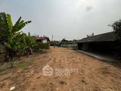 Spacious rural property with open land and rustic outbuildings, ideal for development.