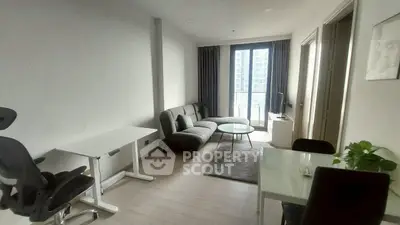 Modern living room with sleek furniture and large window view