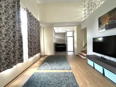 Spacious living room with modern decor and large windows for natural light.