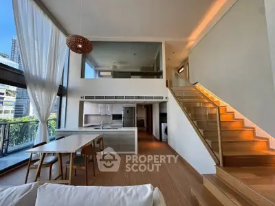 Stunning modern duplex with open kitchen and elegant staircase in urban setting.