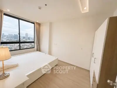 Spacious bedroom with city view in modern apartment