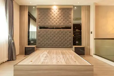 Luxurious modern bedroom with elegant wood paneling and plush headboard