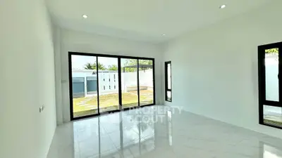 Spacious modern living room with large windows and garden view