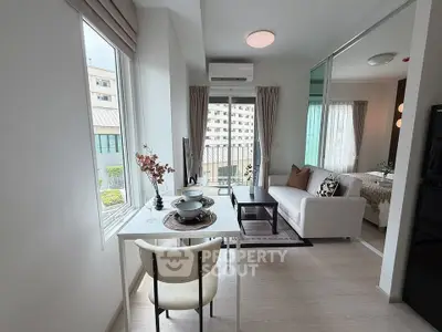Modern living room with dining area and large windows in a stylish apartment