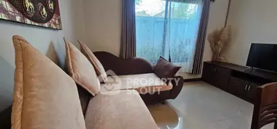Cozy living room with elegant sofa and large window view