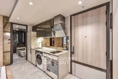 Modern kitchen with integrated appliances and sleek design in luxury apartment.