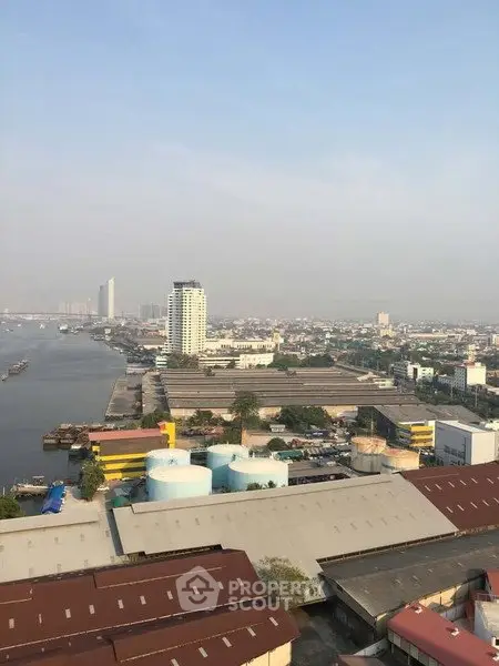 Stunning aerial view of urban landscape with river and city skyline, perfect for real estate investment.