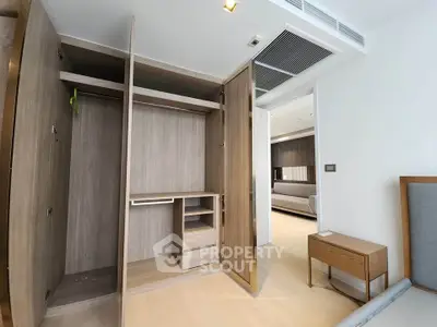 Spacious modern bedroom with open wardrobe and stylish wooden furniture