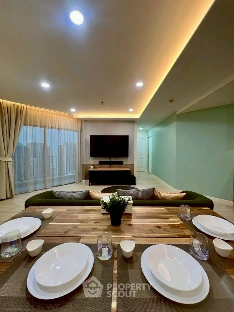 Spacious modern living room with elegant dining setup and ambient lighting