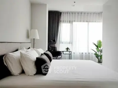 Modern bedroom with large window, stylish decor, and natural light.
