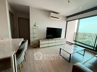 Modern living room with large TV, air conditioning, and balcony view in a stylish apartment.