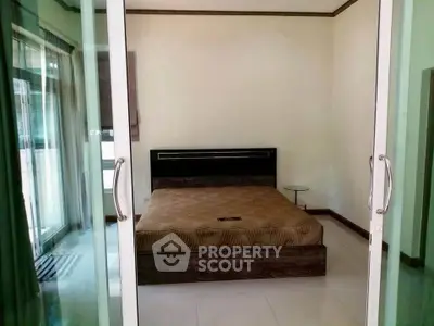 Spacious bedroom with modern design and large windows for natural light.