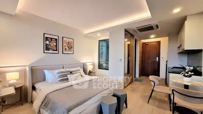 Modern studio apartment with cozy bedroom and stylish kitchen area.