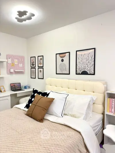 Chic bedroom with modern decor, plush headboard, and stylish wall art.