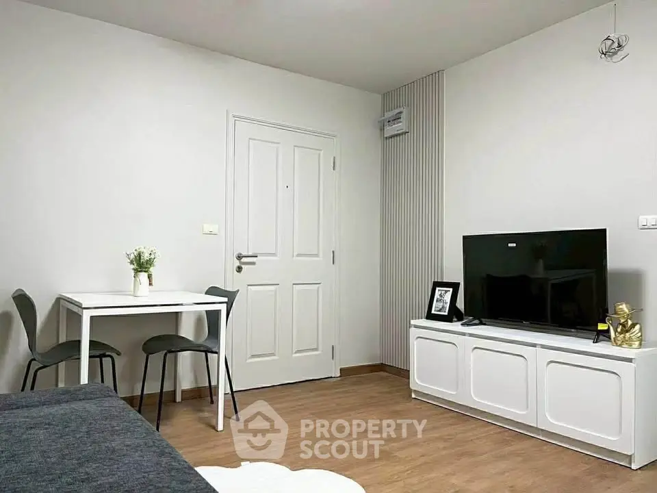 Modern living room with sleek furniture and TV setup, perfect for cozy evenings.