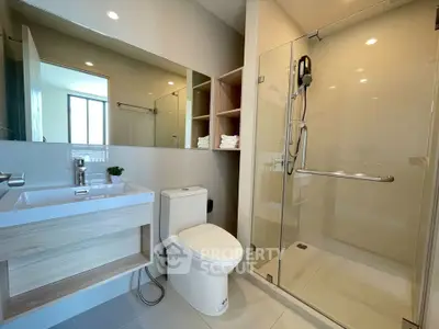 Modern bathroom with glass shower and sleek fixtures