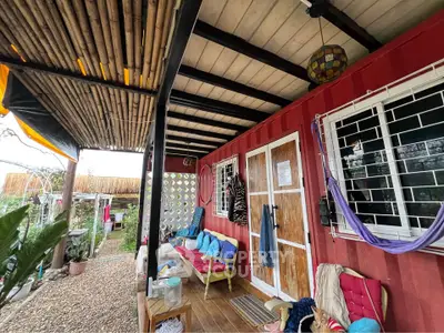 Charming rustic porch with bamboo roof and cozy seating area