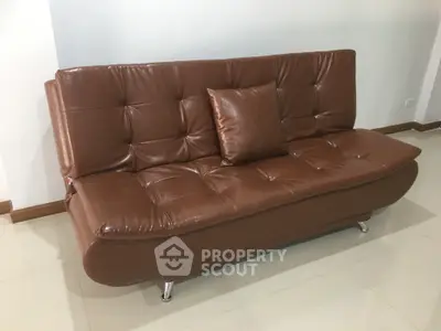 Elegant brown leather sofa in a modern living room setting, perfect for stylish comfort.