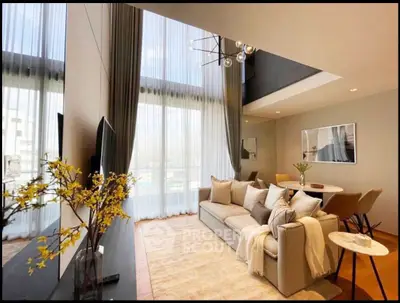 Luxurious living room with high ceilings and modern decor, featuring a spacious sofa and elegant dining area.