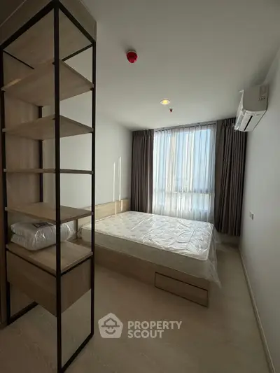 Modern bedroom with natural light, minimalist design, and sleek furniture.