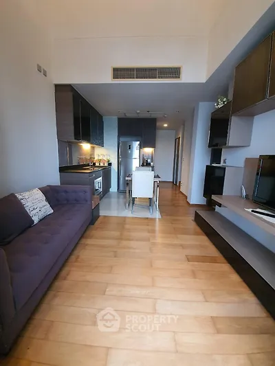 Modern living room with open kitchen layout and stylish decor