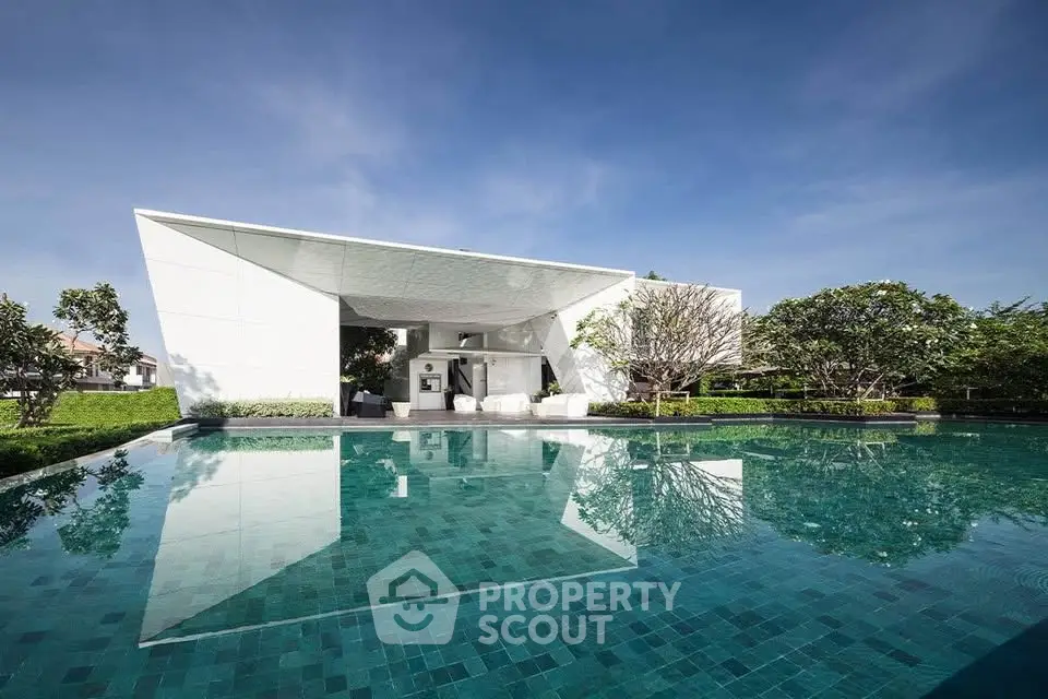 Luxurious modern villa with stunning pool and lush garden, perfect for serene living.