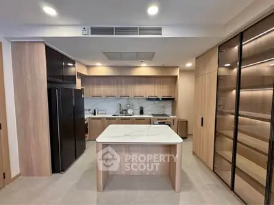Modern kitchen with sleek cabinetry and marble island in luxury apartment