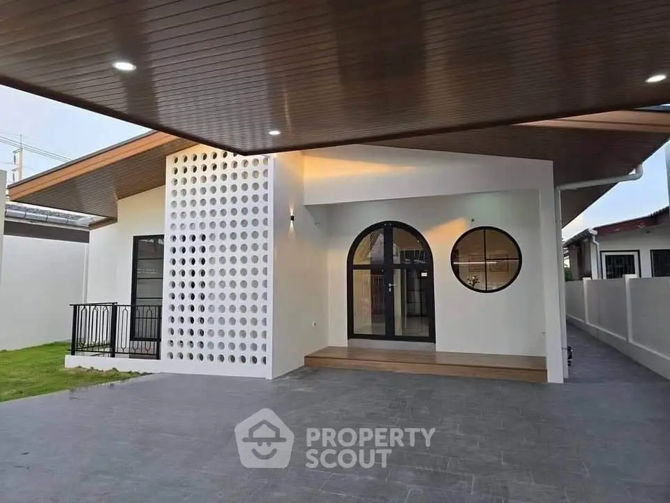 Modern single-story home with stylish facade and spacious driveway.