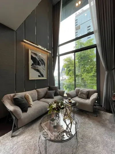 Luxurious high-ceiling living room with modern decor and large windows offering stunning views.