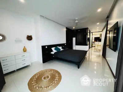 Luxurious modern bedroom with sleek black and white decor, spacious layout, and stylish furnishings.