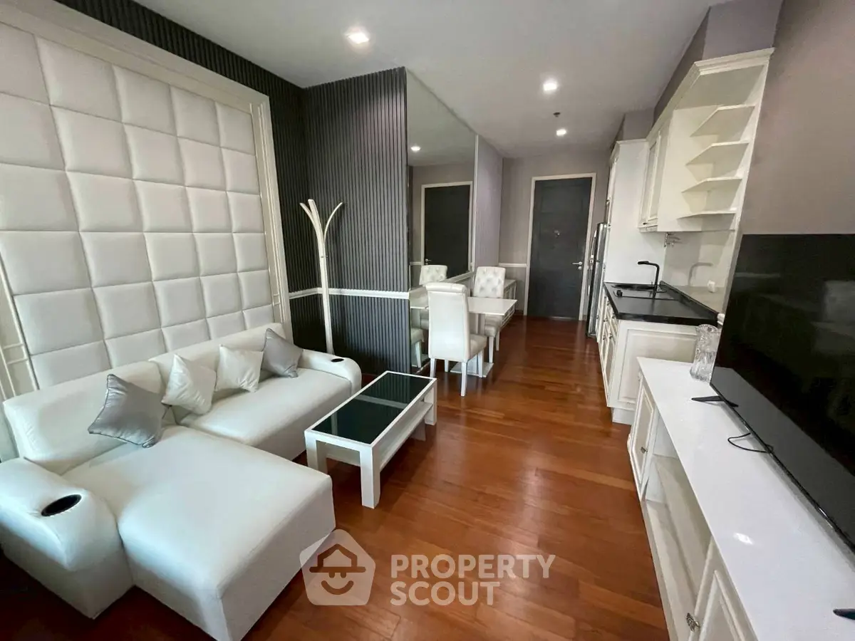Luxurious modern living room with elegant white furniture and sleek wooden flooring