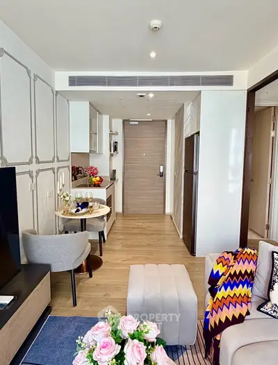 Modern living room with stylish decor and open kitchen layout in a cozy apartment.